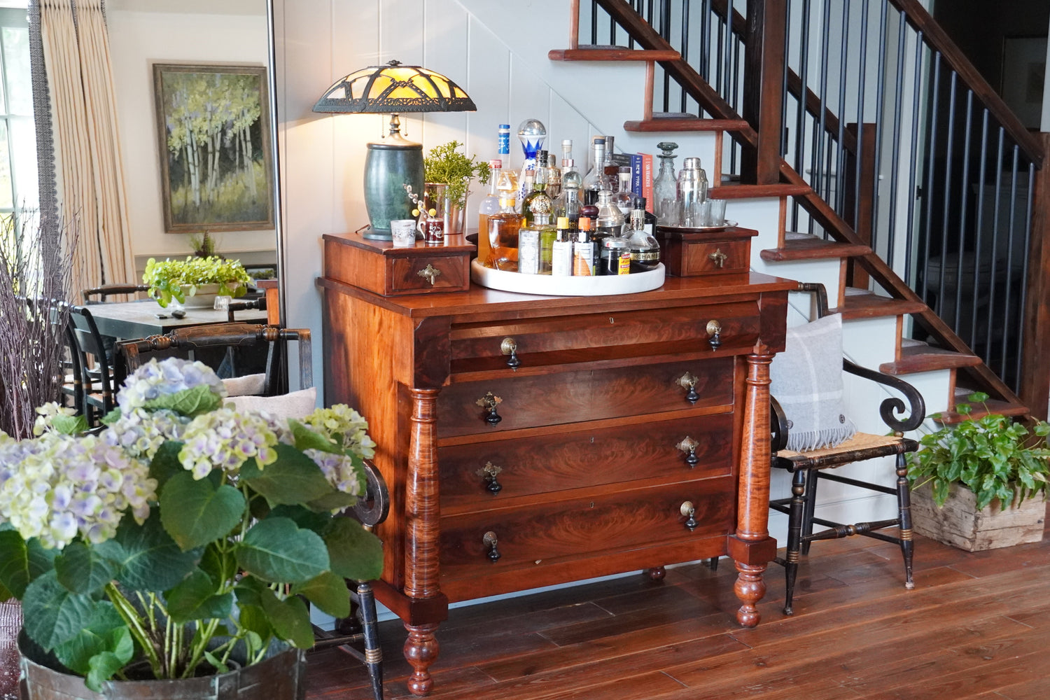 Wooden dresser with drinks and decor in a home setting